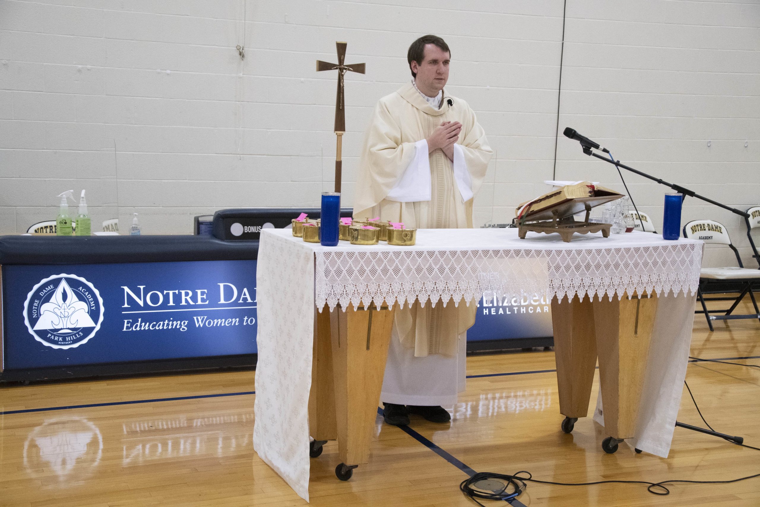 The chaplain saying Mass in the gym on 2021 at the Notre Dame Academy catholic all-girls school in Covington, Northern Kentucky.