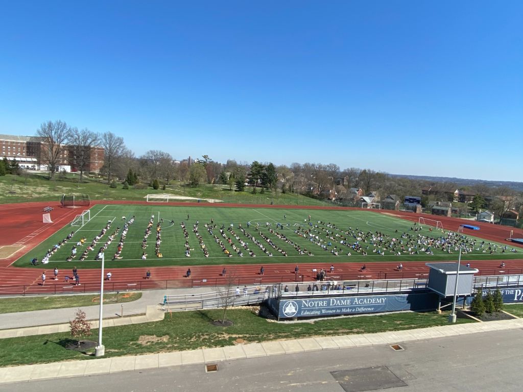 View of a prayer service taking place outside on one of the practice fields at the Notre Dame Academy catholic all-girls school in Covington, Northern Kentucky.