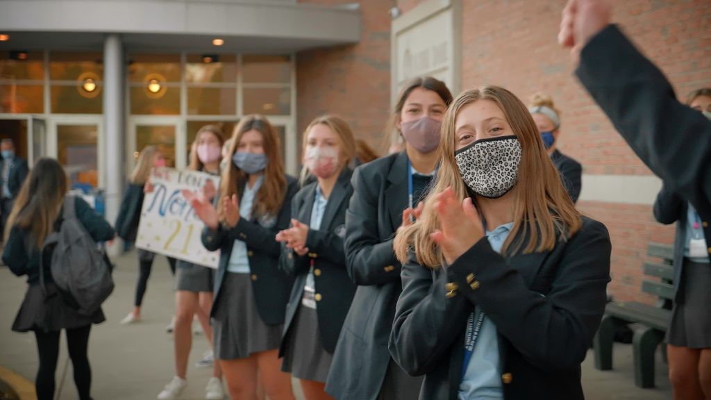 Students standing outside the main entrance welcoming other students at the Notre Dame Academy catholic all-girls school in Covington, Northern Kentucky.