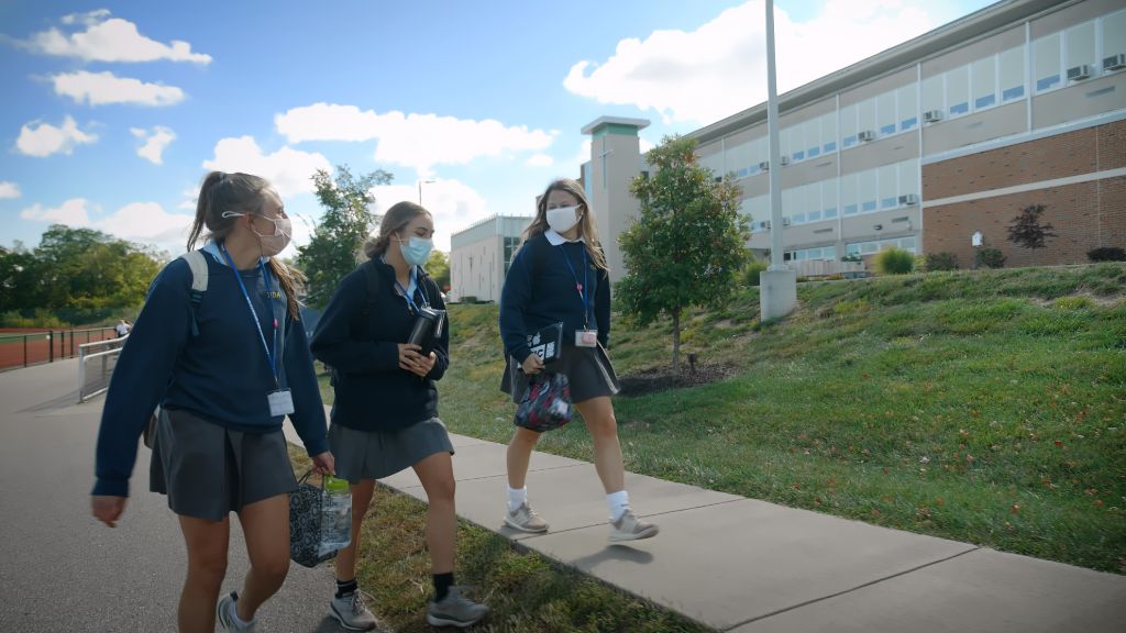 Students walking on a sidewalk outside the main building at the Notre Dame Academy catholic all-girls school in Covington, Northern Kentucky.