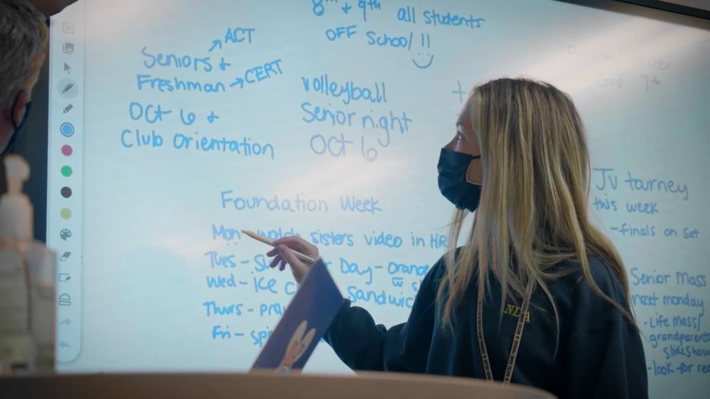 A student standing in front of a whiteboard pointing out information at the Notre Dame Academy catholic all-girls school in Covington, Northern Kentucky.