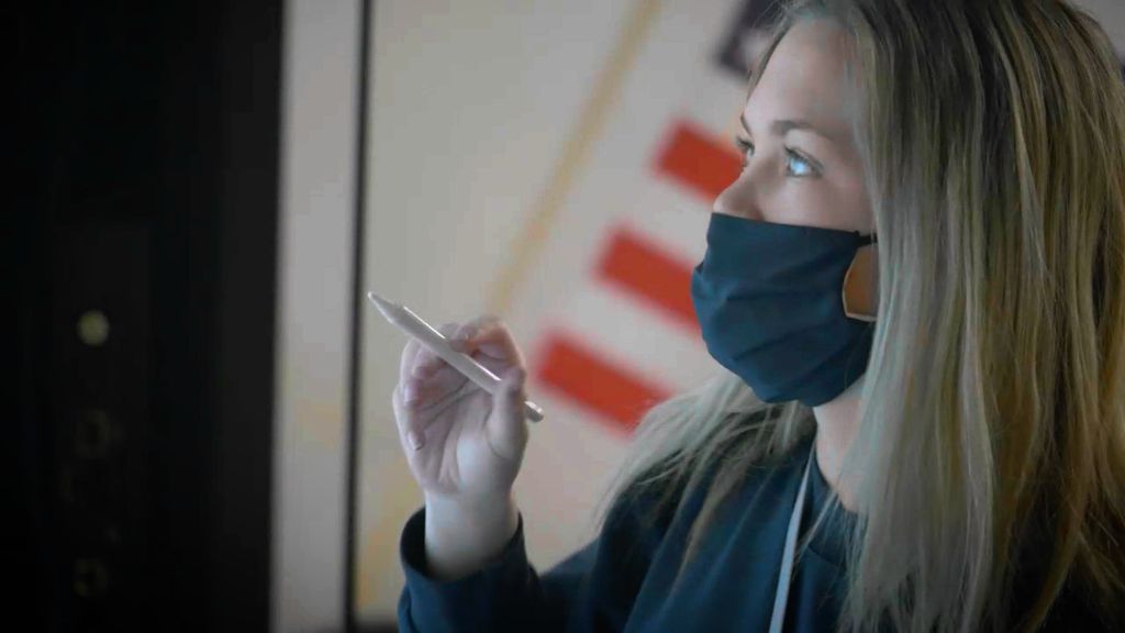 A close up of a student intently studying a whiteboard while about to write something on it at the Notre Dame Academy catholic all-girls school in Covington, Northern Kentucky.