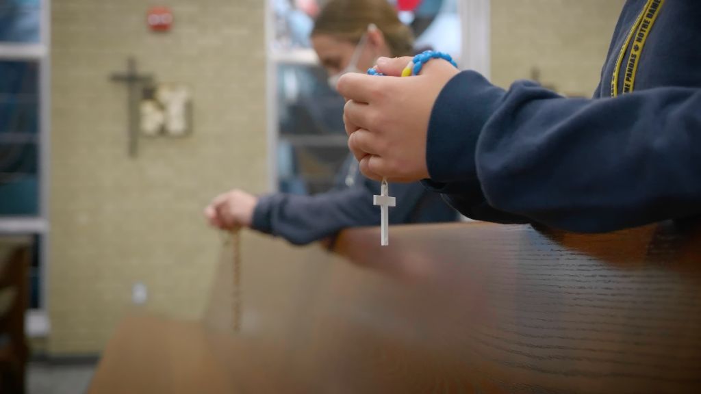 A view of students kneeling at the pews praying the rosary at the Notre Dame Academy catholic all-girls school in Covington, Northern Kentucky.