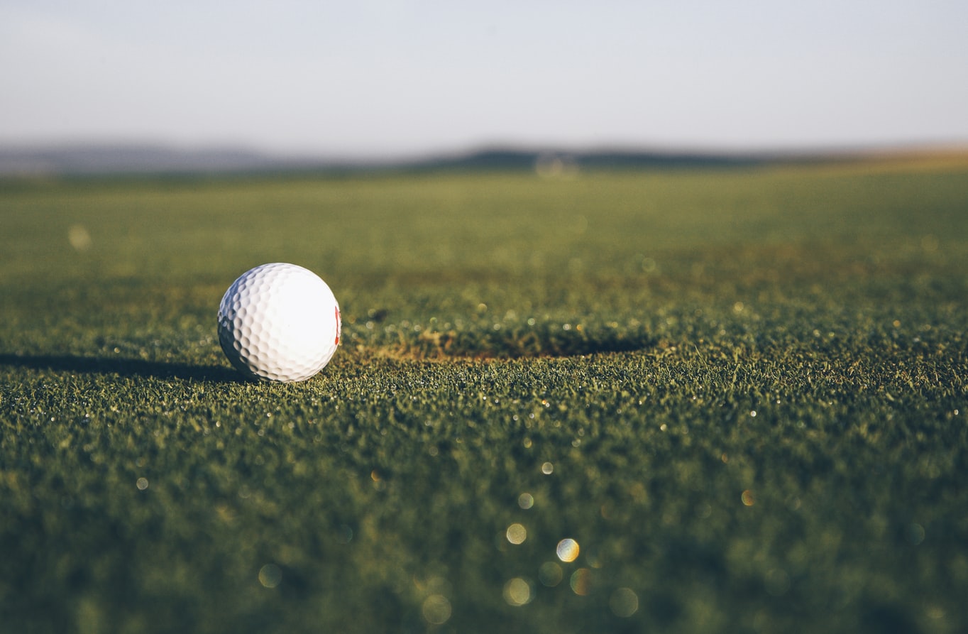 Photo 1576220258822 153014832245 A golf ball rolling into a hole.